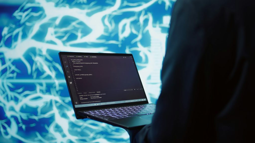 Close up of worker using AI deep learning and laptop to look at data
